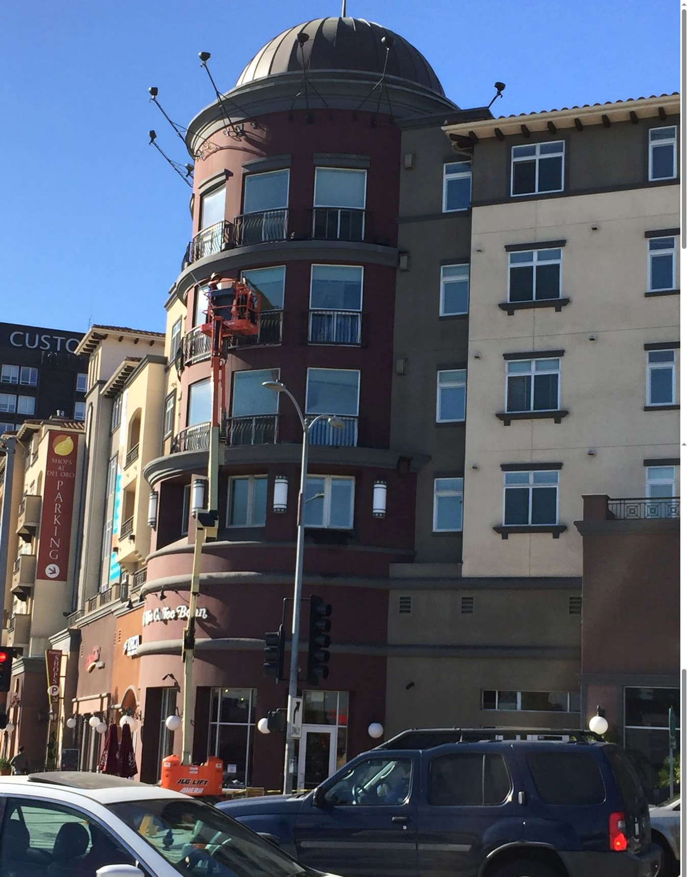 Boom lift positioned for high-access window cleaning at a multi-story commercial building