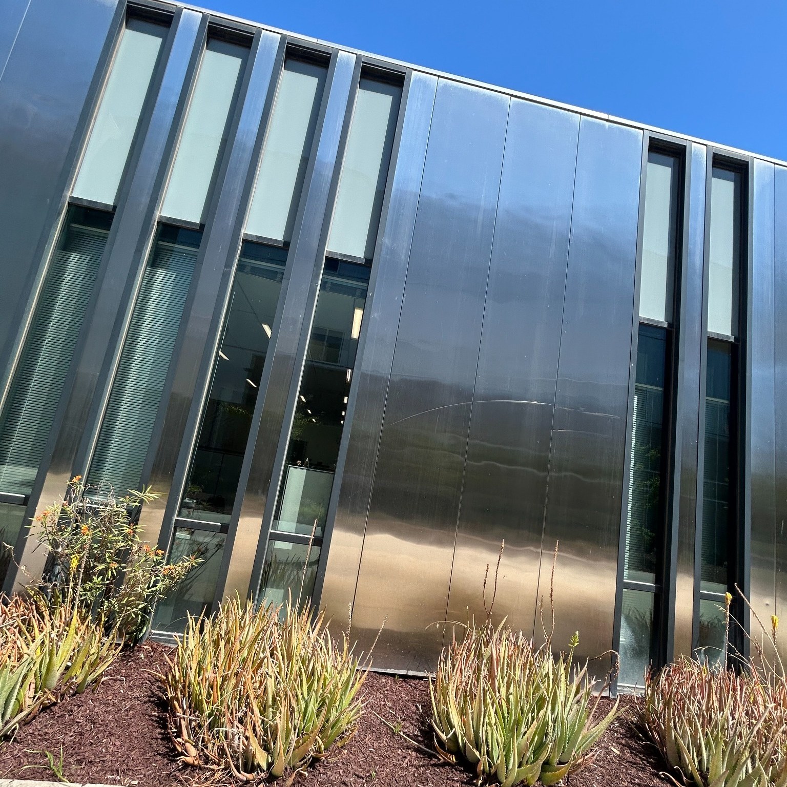 Exterior windows and architectural metal wall panels at a college campus in Huntington Beach.
